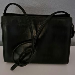 Liz Claiborne leather black purse, textured detail at the top, extra long strap.